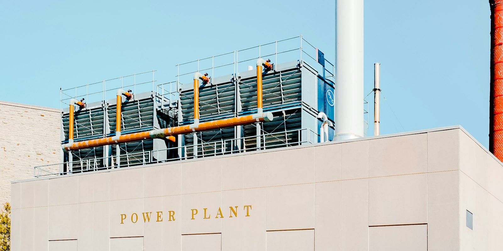 Power generation plant with smokestacks during the day