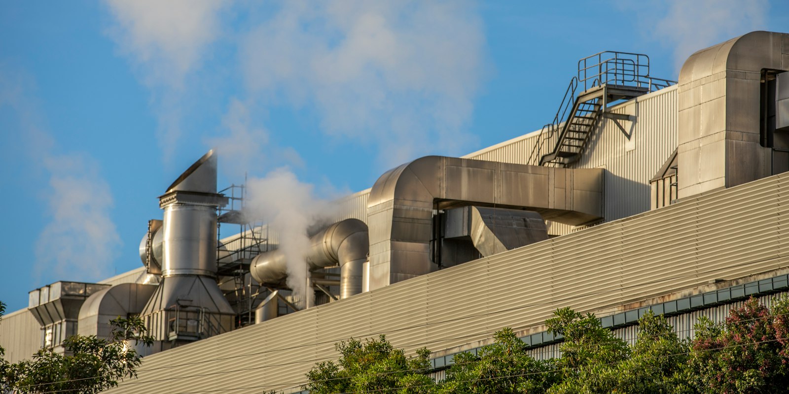 Industrial factory smokestacks releasing steam