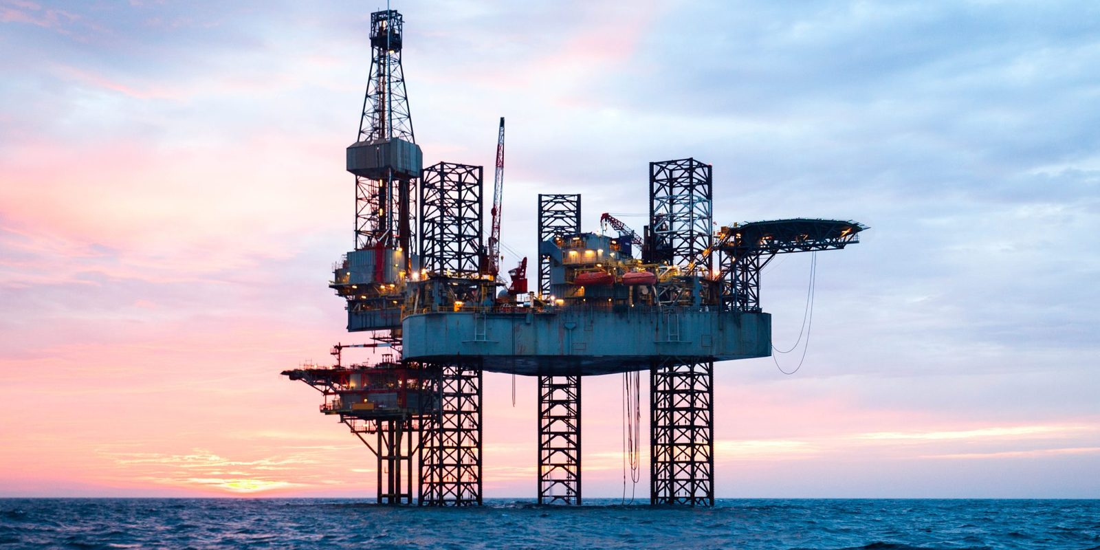 Offshore oil and gas platform at sunset
